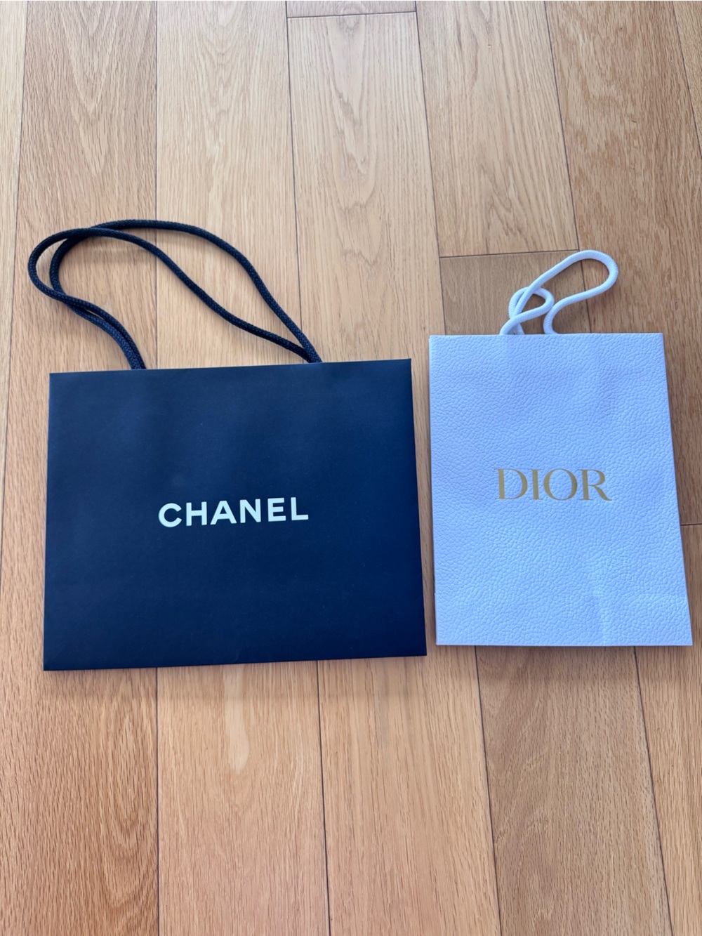 Chanel black and Dior white empty shopping bags